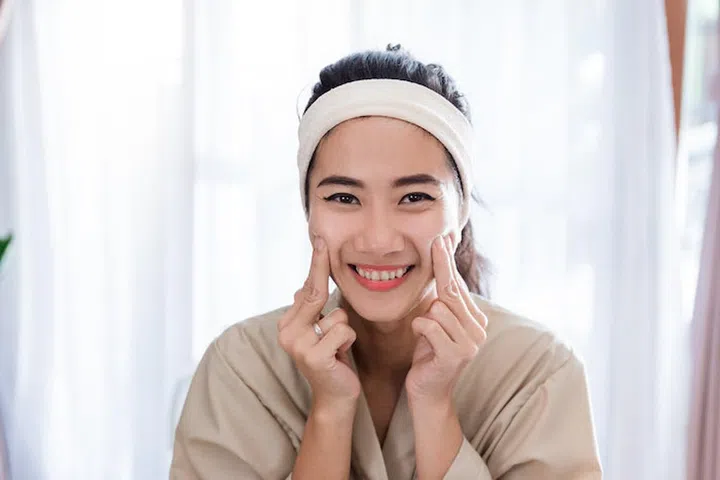 Young woman self face  massage at home