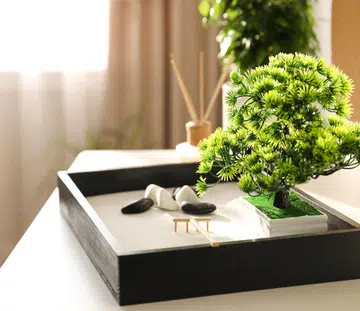 Beautiful miniature zen garden on white table indoors