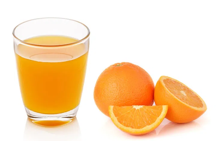 Fresh orange and glass with juice