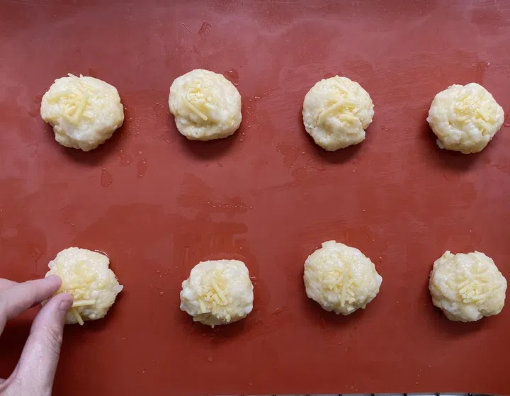 05. Optional: Add an extra pinch of cheese on top of each ball.