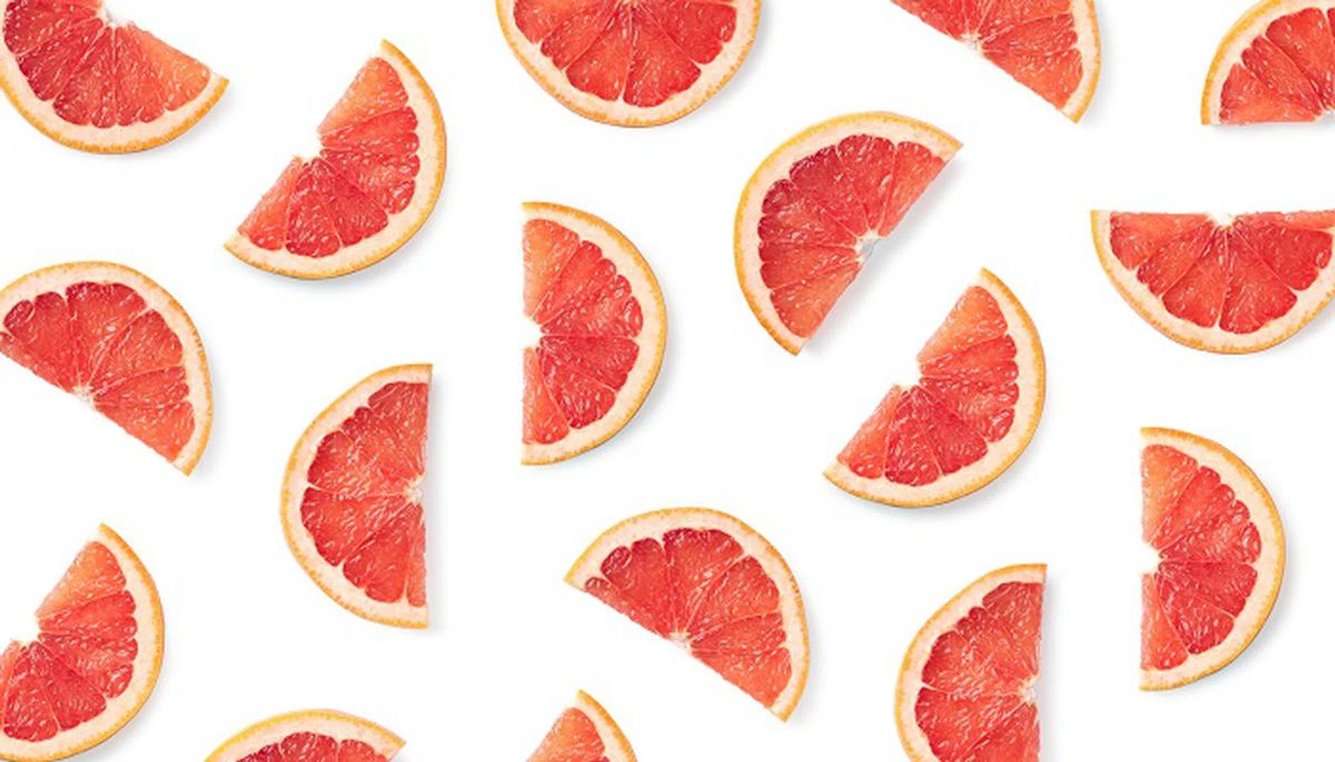 Fruit pattern of grapefruit slices isolated on white background. Top view. Flat lay