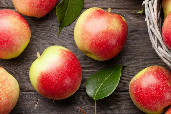 Ripe garden apple fruits on wooden table. Top view flat lay