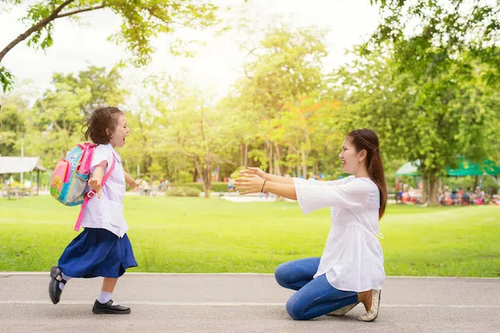 60350783 - family, kids and mother - kids student running into mother's hands to hug her. family having fun in the park. kids is happy to meet her mother