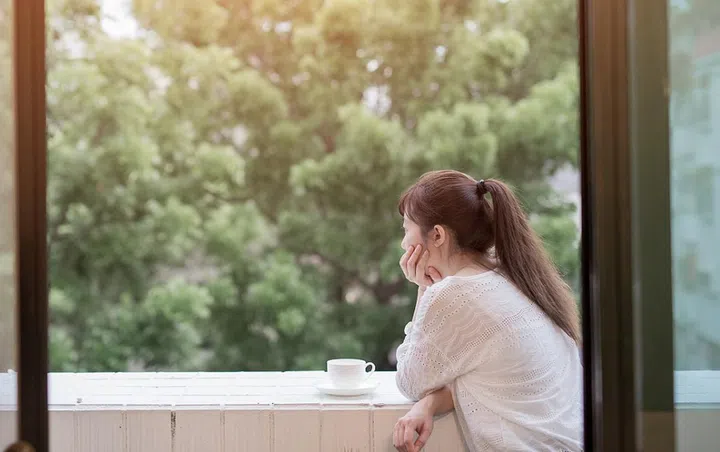 woman feel depression and look somewhere next to the balcony