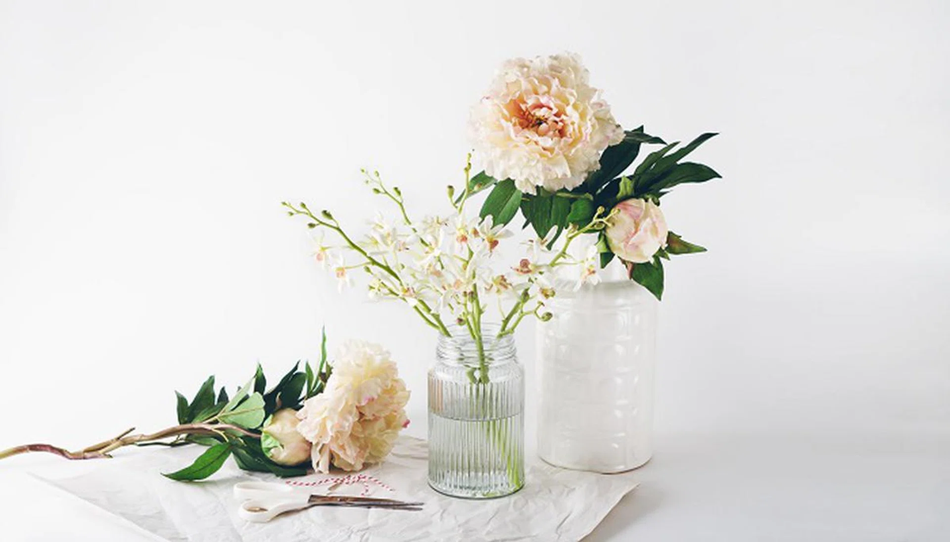 Florist preparation with a selection of vases scissors and string horizontal