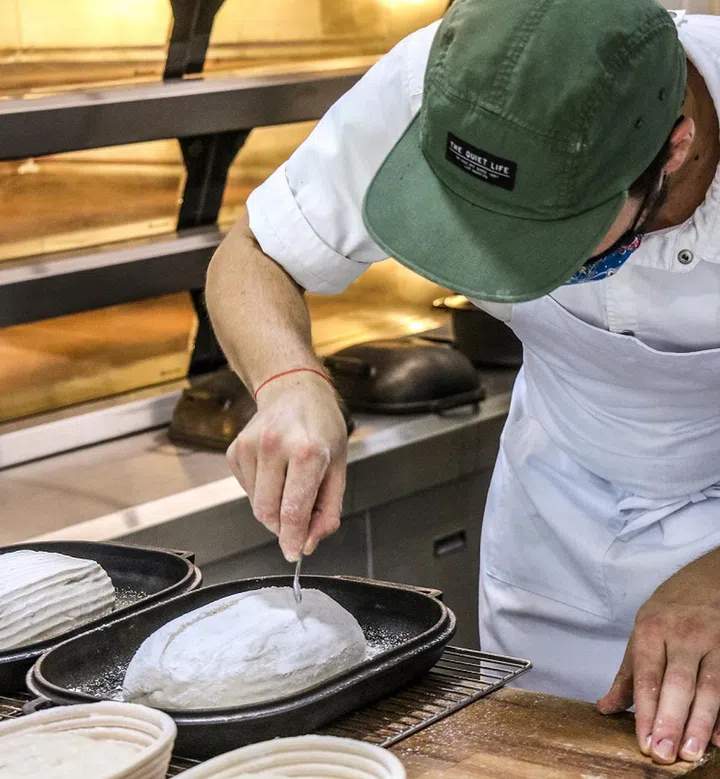 02. Score the dough with your blade, place the dough in the dutch oven with the lid on before putting it into the oven. Bake it for 25 to 30 minutes at 240°C.