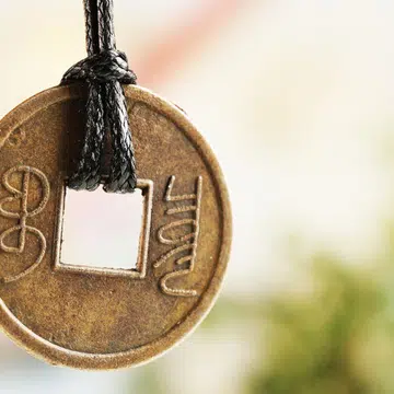 Feng shui coin on light background