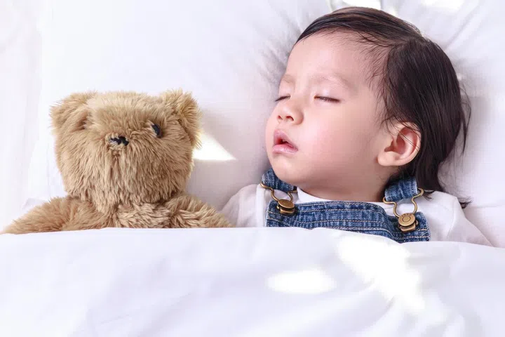 Kid asian girl sleeping in her bed