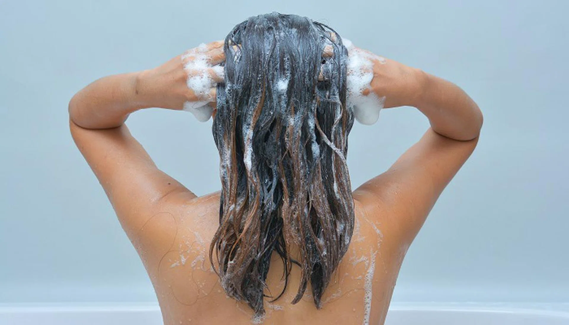 34356645 - woman taking a shampoo, shower