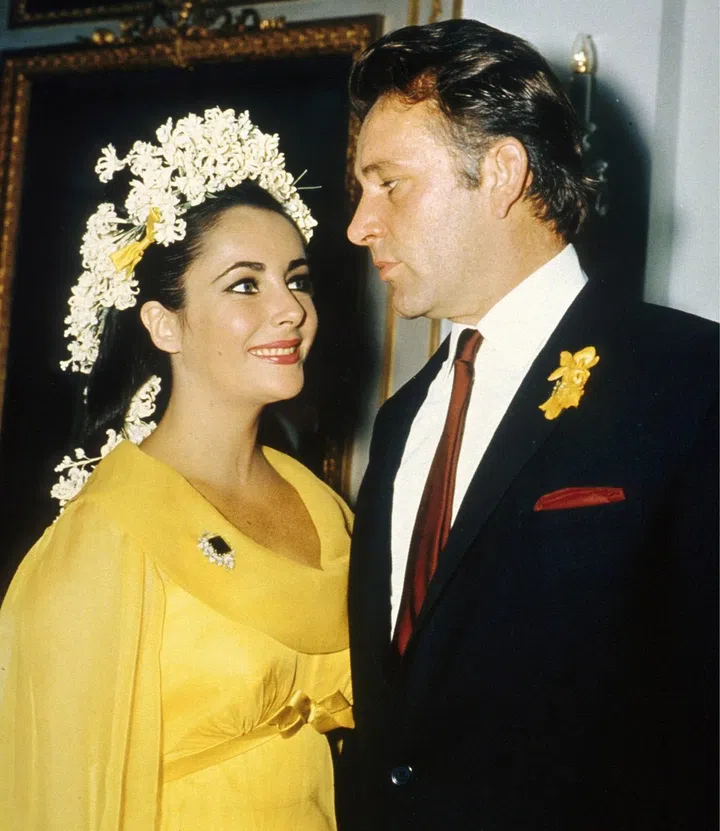 Veteran Hollywood actress Elizabeth Taylor, smiling in a photograph taken with actor Richard Burton during their wedding in 1964. The only piece of jewellery she can be seen wearing here is a 23.44-carat Colombian emerald brooch surrounded by pear-shaped diamonds from Bulgari, an Italian high-end jewellery and luxury goods maker.