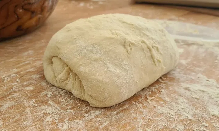 01. Items needed: Water and some flour
01. Remove the dough from the bowl and place it on a lightly floured surface. Wet your hands with water and do the first fold (tight) on the dough. Using both hands, gently stretch one end of the dough upwards and fold it over the centre. Do this on four sides of the dough (North, South, East, West).