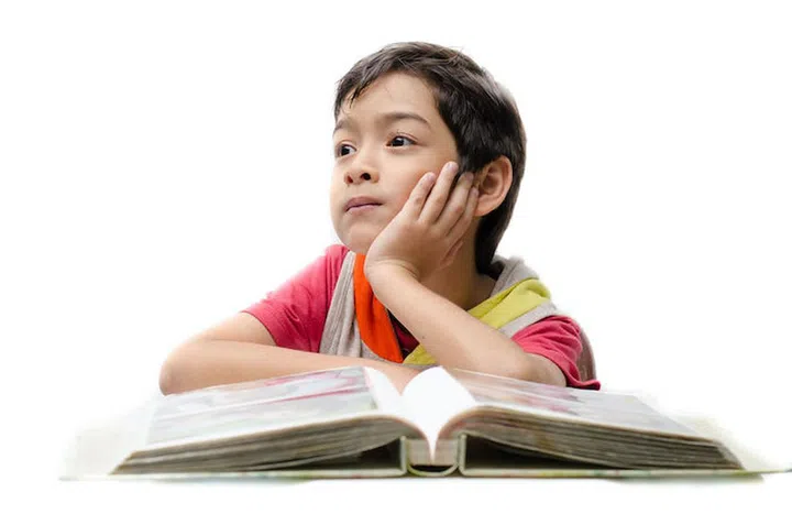 Little boy reading a book and think on white background