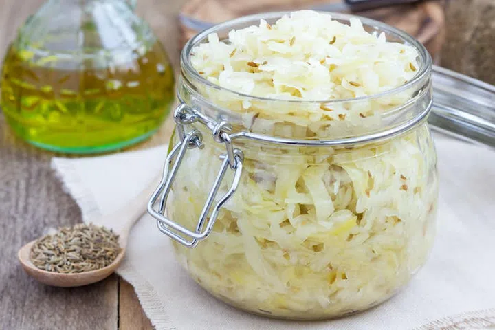 Homemade sauerkraut with cumin in a glass jar 