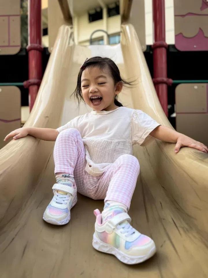 ST executive photojournalist Gavin Foo knew his daughter Clovelly would head for the slide and waited there patiently to take this photo. PHOTO: GAVIN FOO