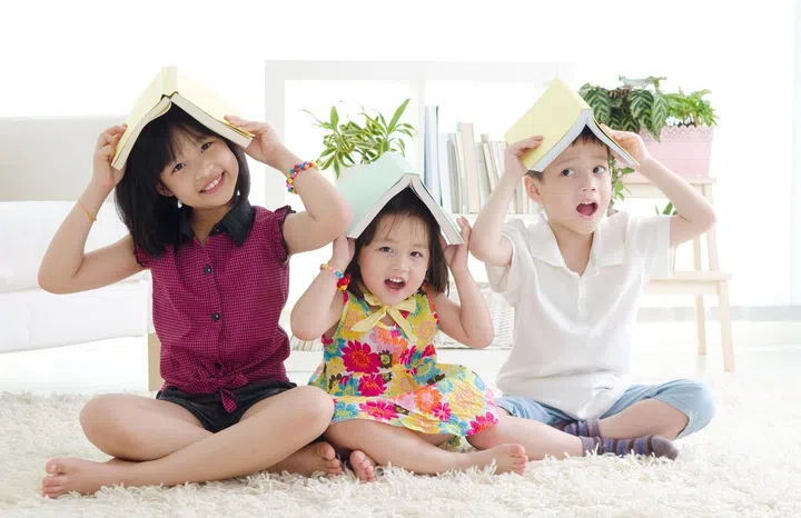 30636417 - asian kids putting books on their head