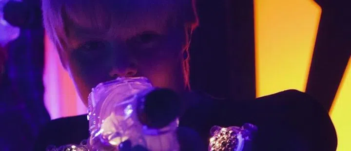 A boy playing laser tag.  Photographed at a high ISO under blacklight to capture true look and feel of the game.