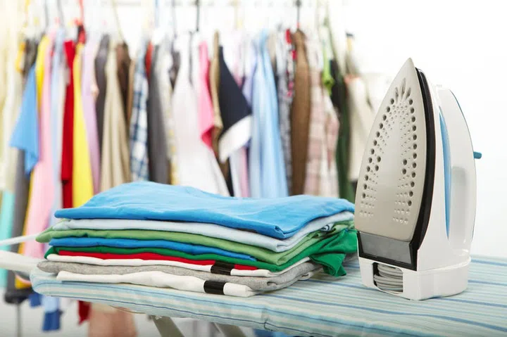 35343417 - electric iron and shirt, on cloth background