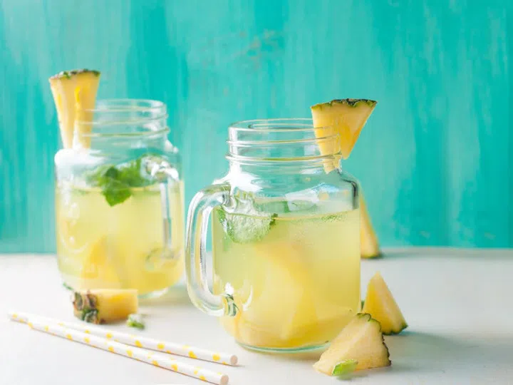 Pineapple lemonade with lemon and mint, selective focus