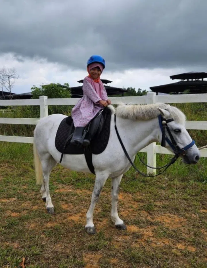 Nur Faathimah Assyifa' riding a pony in September. PHOTO: COURTESY OF NUR SYAHIDAH WATIB