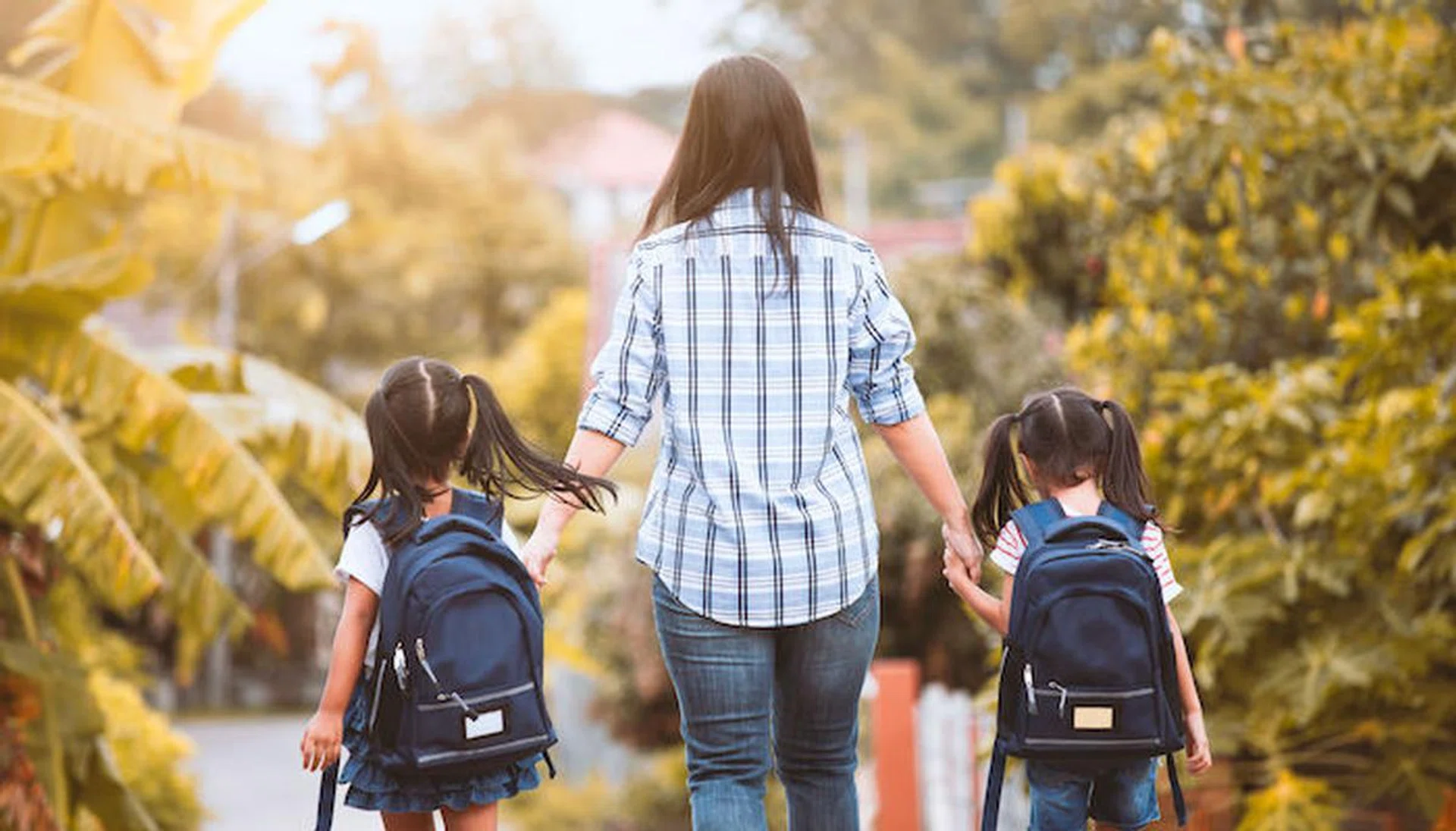 Back to school. Asian mother and daughter pupil girl with backpack holding hand and going to school together in vintage color tone