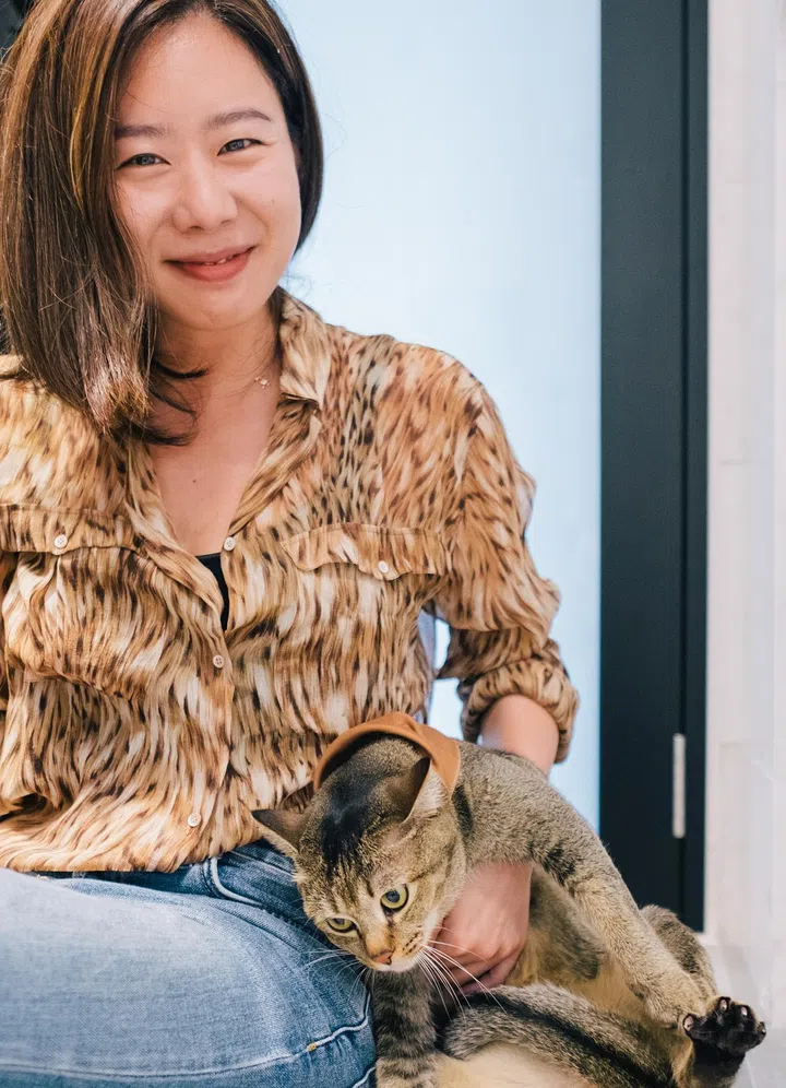 Athena with one of her cats.