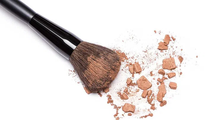 Here's how that works: take a bronzing brush or stipple brush, sweep it over your powder bronzer, tap off any excess and sweep lightly along the hairline from temple to temple.