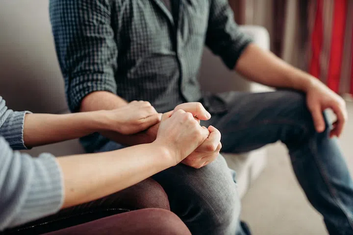 Couple hold hands at psychologist, family psychology support, civilized solution to the problem. Female doctor helps patients with consultation