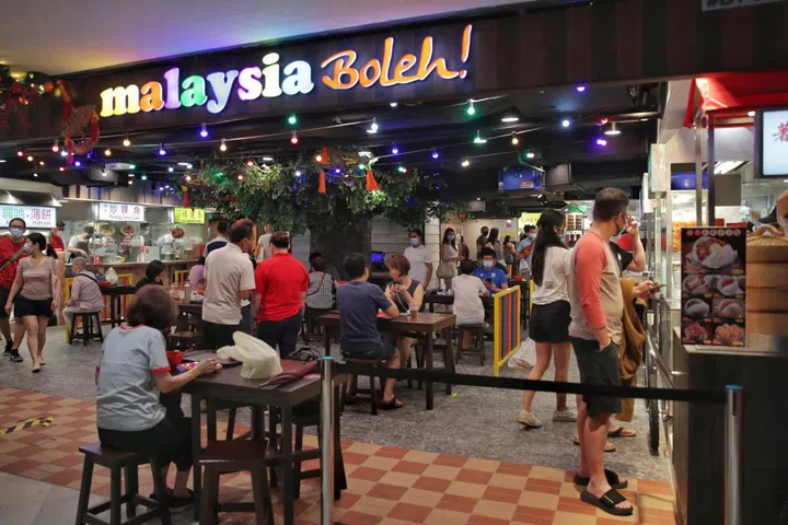 Diners eating at the Malaysia Boleh! in i12 Katong, on Dec 24, 2021. ST PHOTO: GIN TAY