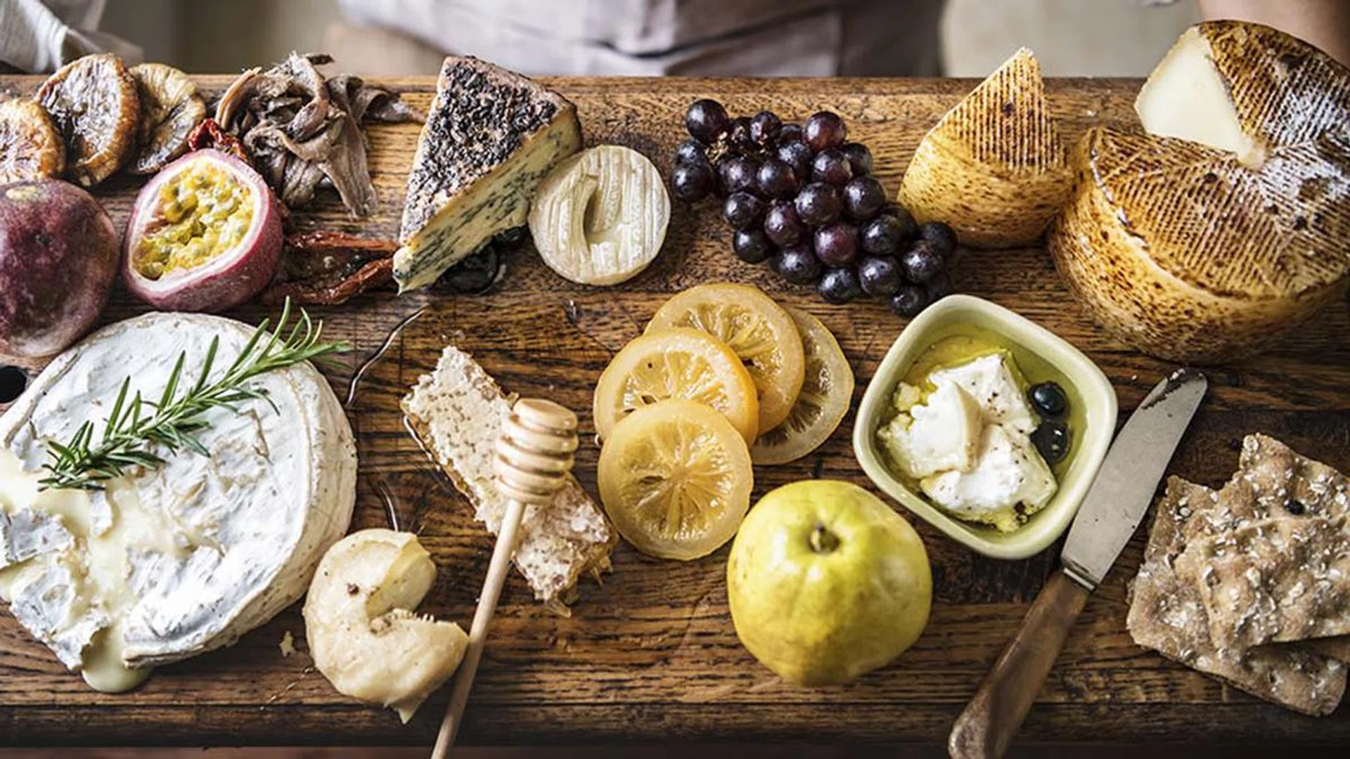 A person holding a cheese platter