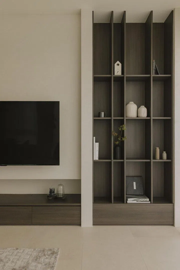 Full-height open display shelves sit to the right of the television console in this private condominium apartment in Serangoon Gardens. Image: Home & Decor