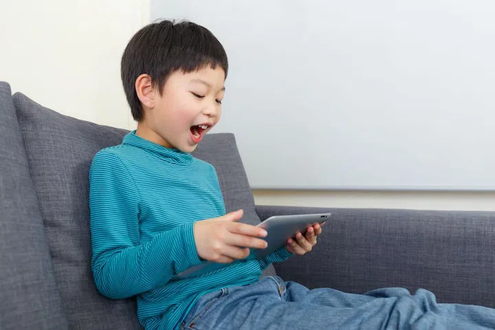 Asian little boy feel exciting for using tablet