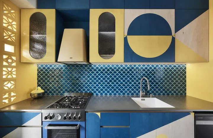 Bold circular shapes in yellow and teal colour blocks for the kitchen cabinets.