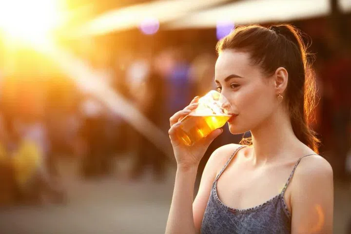 Woman Drinking Beer Outdoors. Attractive Girl With Beer Glass On Festival. High Resolution