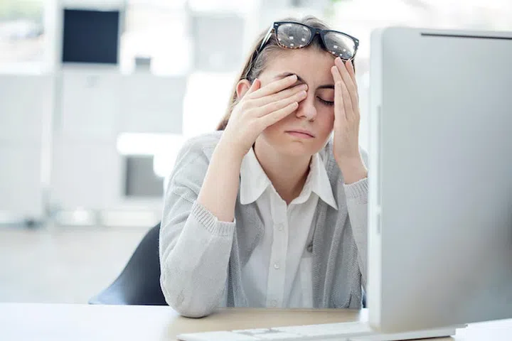 Tired woman touching her eyes