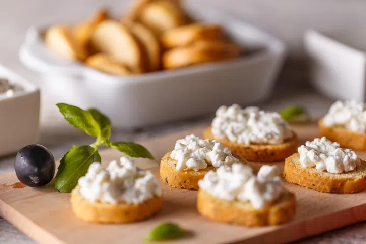 Bruschetta with cottage cheese on a cutting board