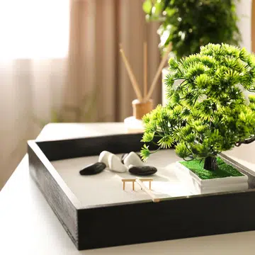 Beautiful miniature zen garden on white table indoors