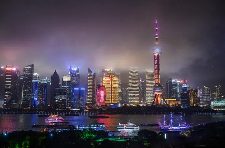 SHANGHAI, CHINA - AUGUST 28: Boats travel on the Huangpu River as the skyline of the city is is seen, including the Oriental Pearl TV Tower and the Shanghai Tower, on August 28, 2020 in Shanghai, China. (Photo by Kevin Frayer/Getty Images)
