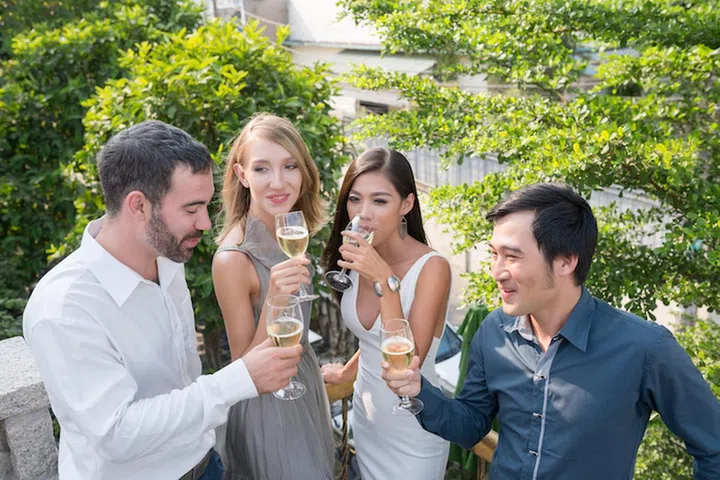 People drinking champagne and celebrating something at cocktail party