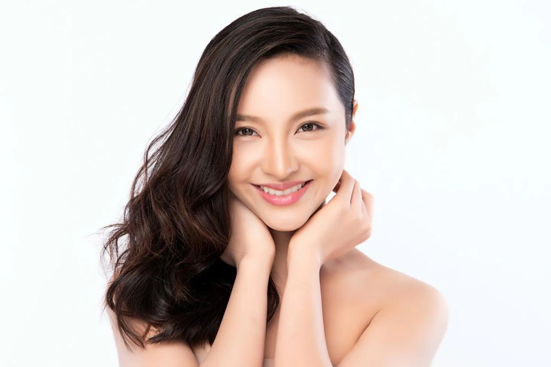pretty asian woman with flowing hair over one shoulder