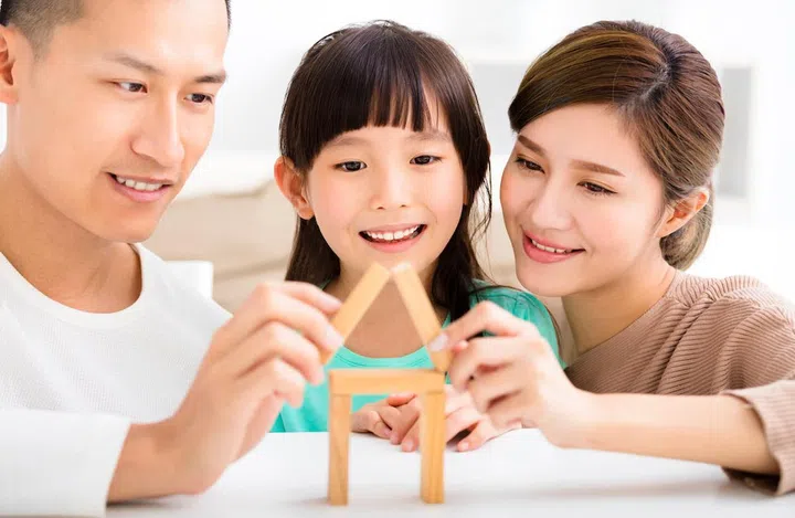 happy family playing with toy blocks