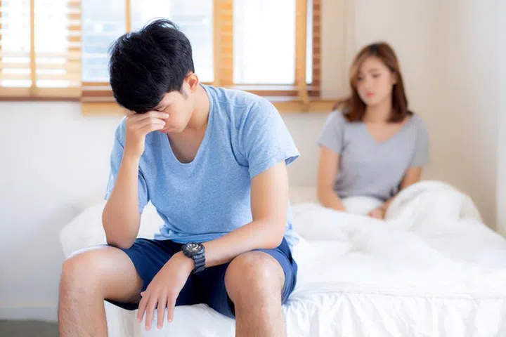 Asian young couple having problem of man worried impotent and unhappy at bedroom, trouble divorce of family with frustrated