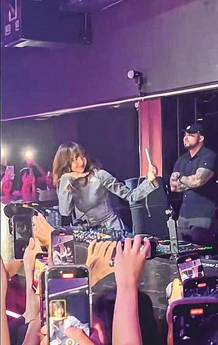 Lisa拿起粉丝的手机一起合照。（取自网络）