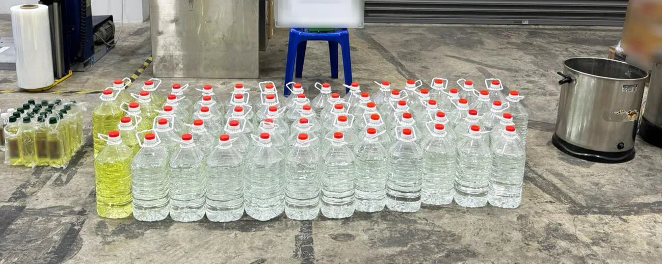 63岁马来西亚女子涉运送漏税酒，关税局循线捣毁一个私酿酒的住家，起获105瓶容量不一的漏税酒和两台小型蒸馏器。（新加坡关税局提供）