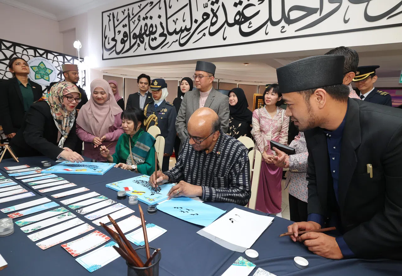在文莱进行国事访问的尚达曼总统（坐着右）和夫人珍一藤木（坐着左）星期五下午参观了伊斯兰书法艺术研究中心，并尝试了爪夷文（jawi）书法。尚达曼过后在脸书贴文说，这种书法与他经常写的中国书法很不一样，因为使用的不是毛笔，而是硬笔尖的竹笔。 （唐家鸿摄）