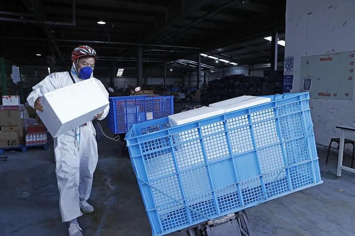 4月9日，在京东物流上海虹口营业部，快递人员正在搬运物品。为助力上海物资保供，阿里、美团、京东、叮咚买菜、拼多多等互联网平台都宣布从各地增派人手、保障物资。（中新社）