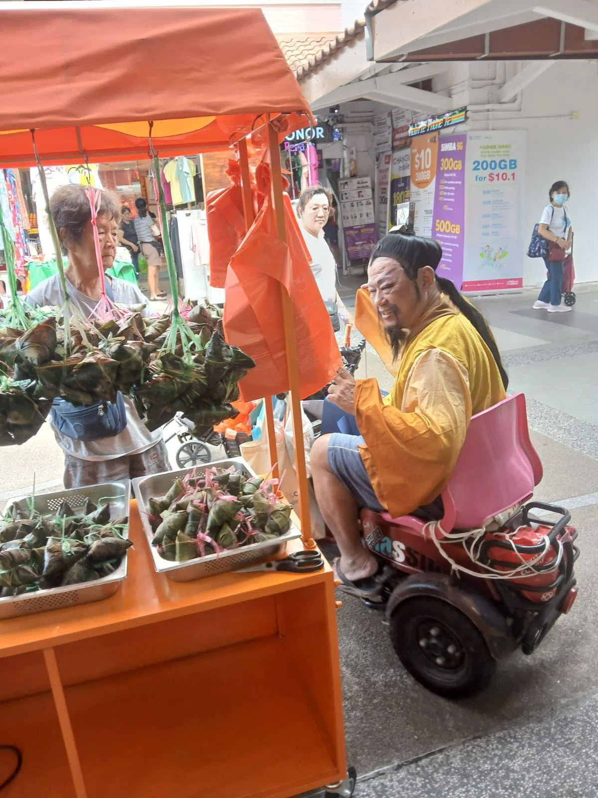 罗任达（右）会在端午节前后戴上头套、穿上古装，扮成屈原唱古风歌。（受访者提供）