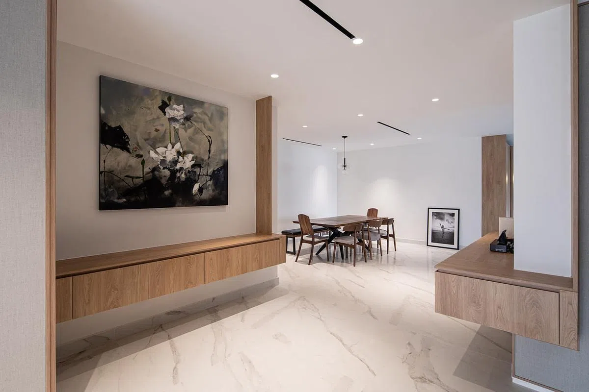 长廊另一面墙的“一横一竖”框起带水墨韵味的荷花油画。设计师刻意不打灯，让花显现于暗影之中，更显出它的韵味。（Metre Architects提供照片）