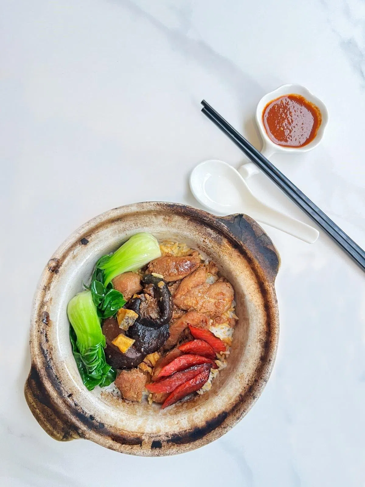 鸡肉砂煲饭饭焦均匀，鸡肉又嫩又香。（酒店提供）