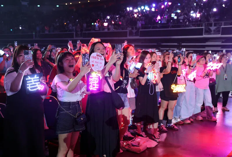 台下歌迷热烈地为各自的偶像成员举牌打气。（萧紫薇摄）