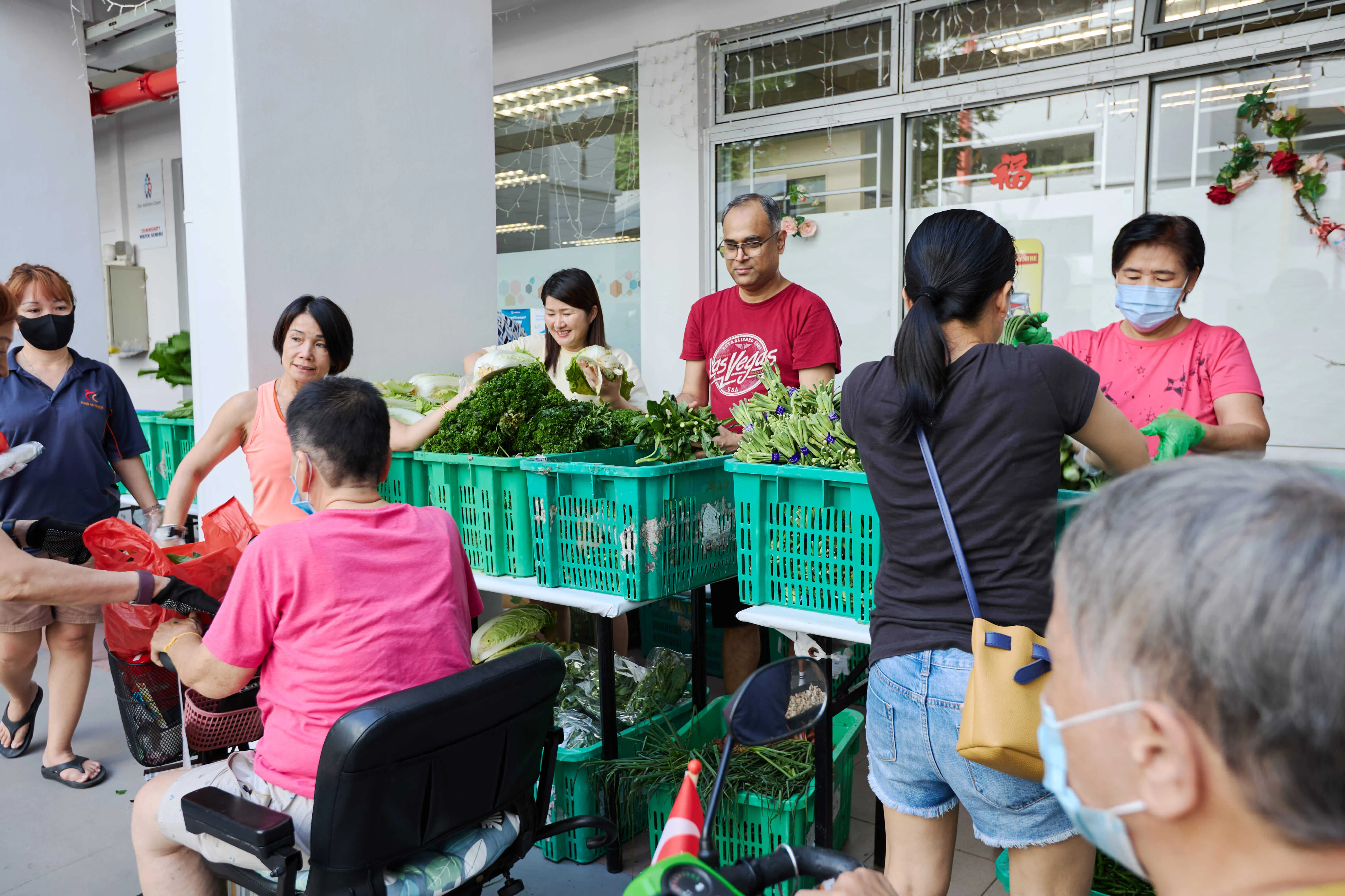 在居民的积极响应下，参与派发蔬菜的义工人数从最初的六七名增加到现在的30多名。（图／新报业媒体）